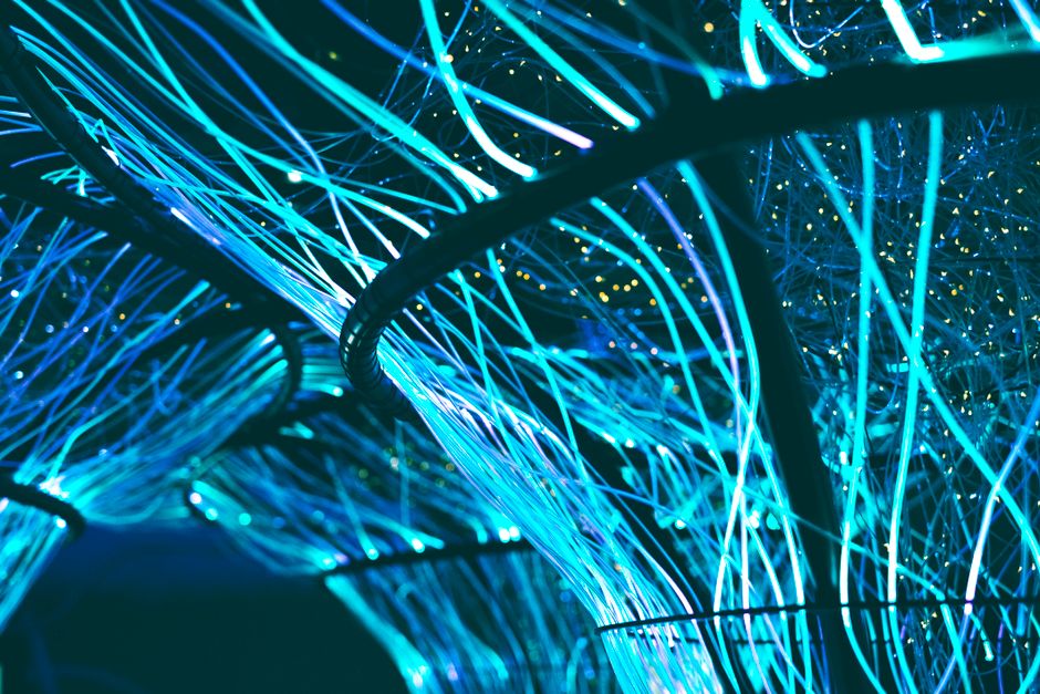 Mesmerizing display of glowing neon blue optical fibers